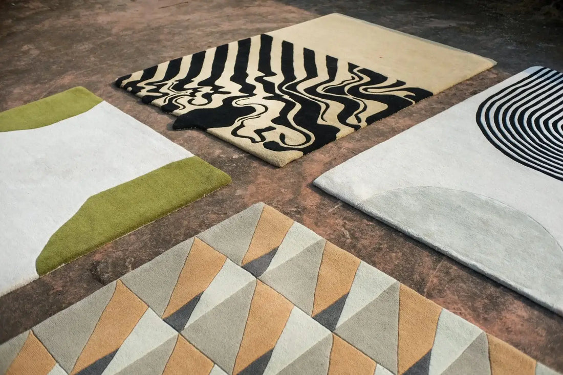 four modern handmade rugs laid on the floor
