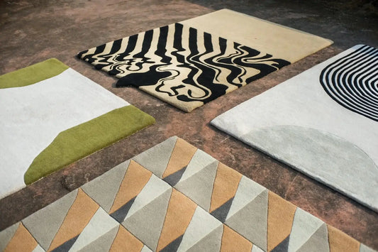 four modern handmade rugs laid on the floor