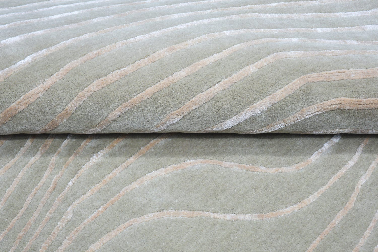 close view of shaped hand-tufted grey wool rug for living room