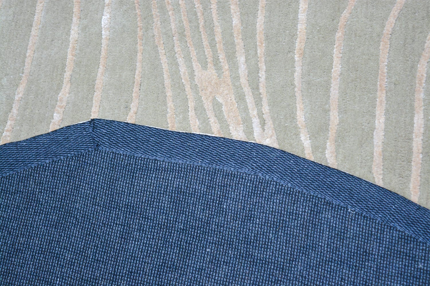 backing of shaped hand-tufted grey wool rug