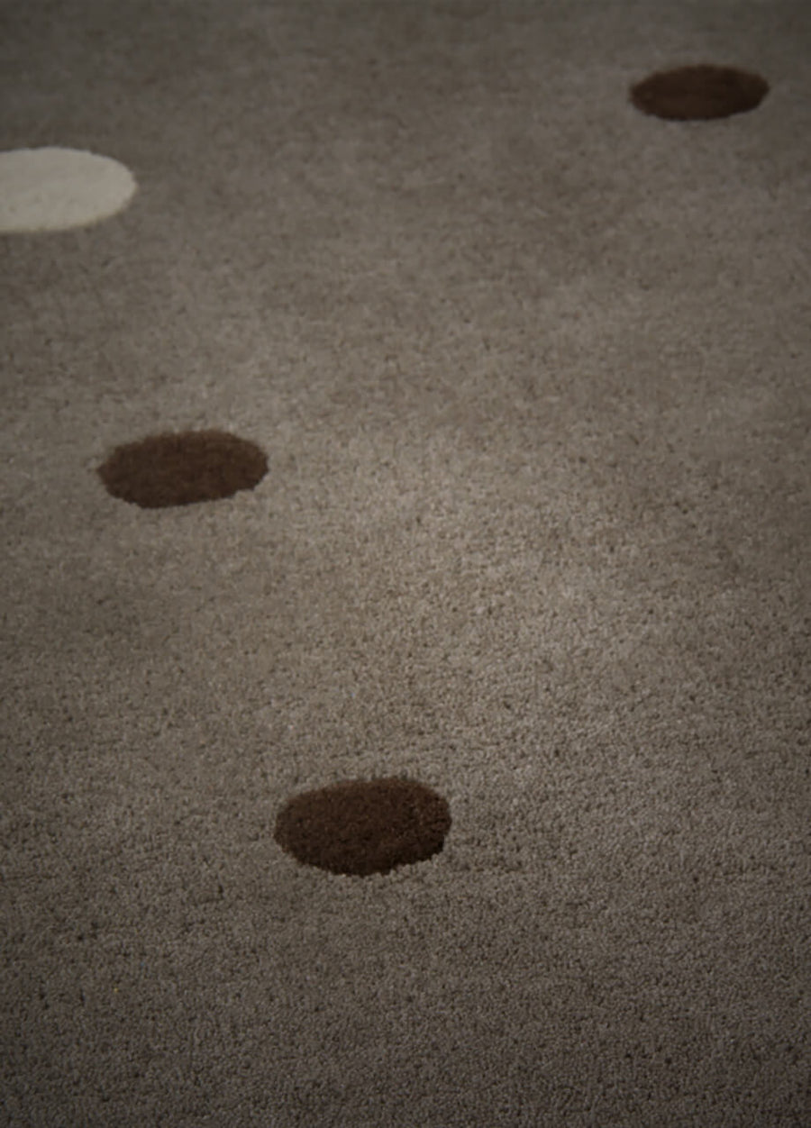 close view of modern polka dot hand tufted wool rug in grey