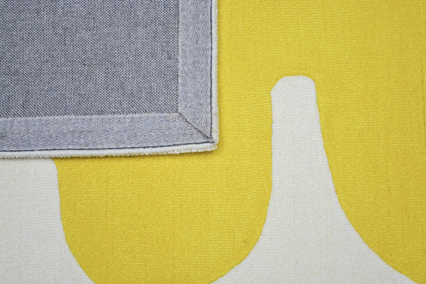 Terracotta yellow and white wool rug, back side of rug