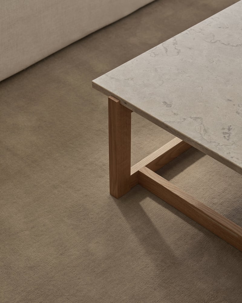 table on beige hand-tufted wool rug
