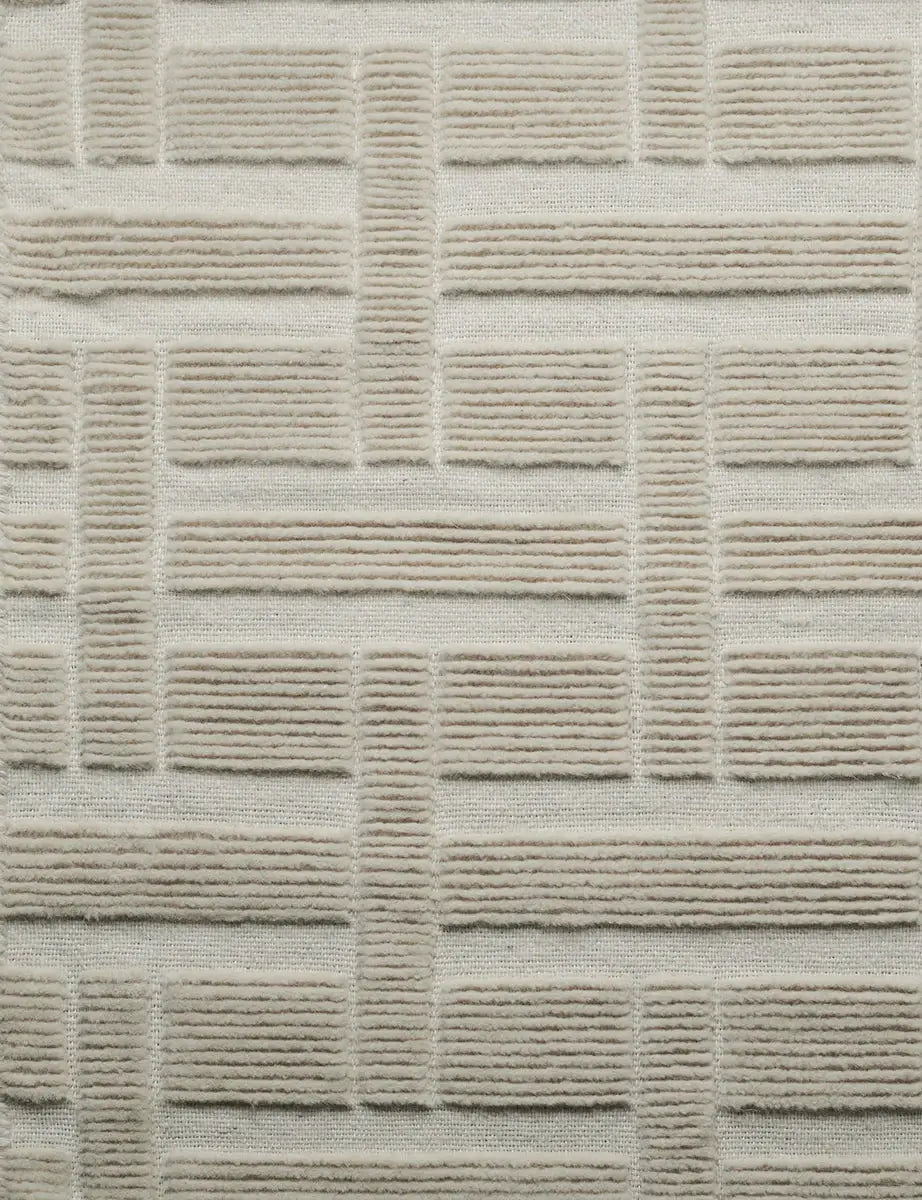 close view of hand woven wool rug with artistic pattern