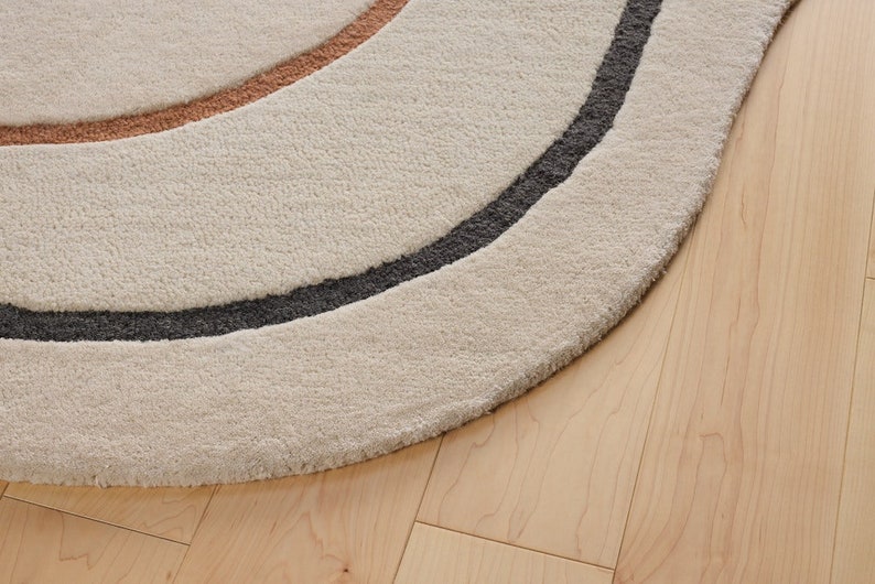 close view of Humma shaped beige wool rug