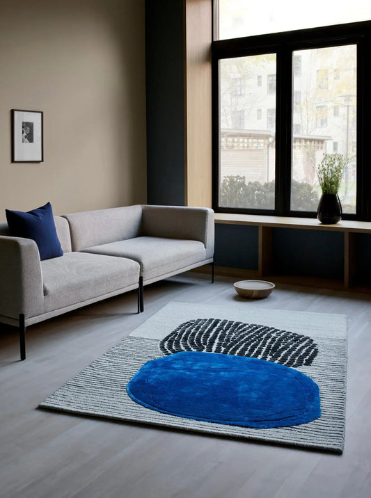 modern hand tufted blue wool and silk rug in living room