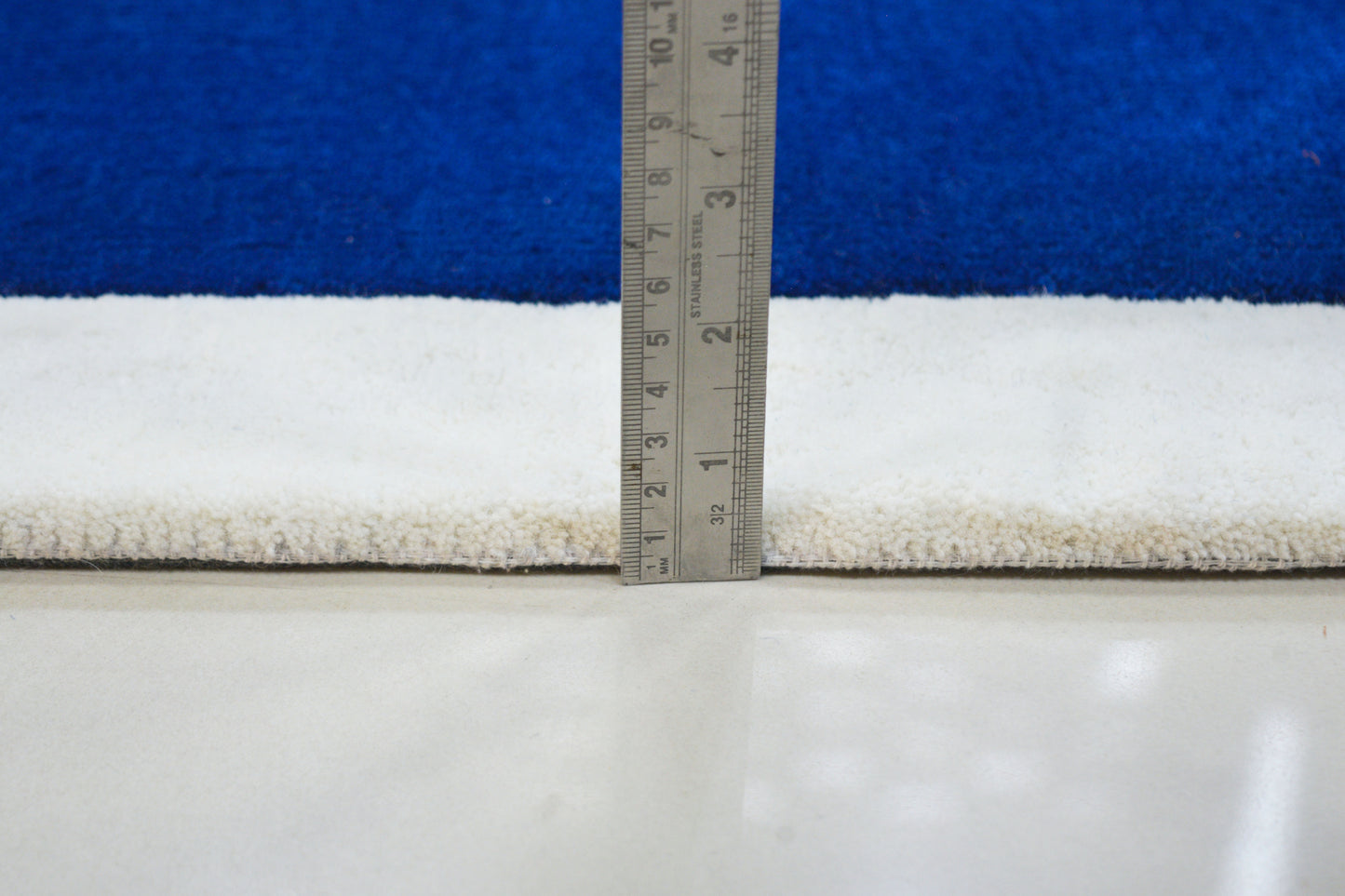showing pile height of blue hand tufted wool rug