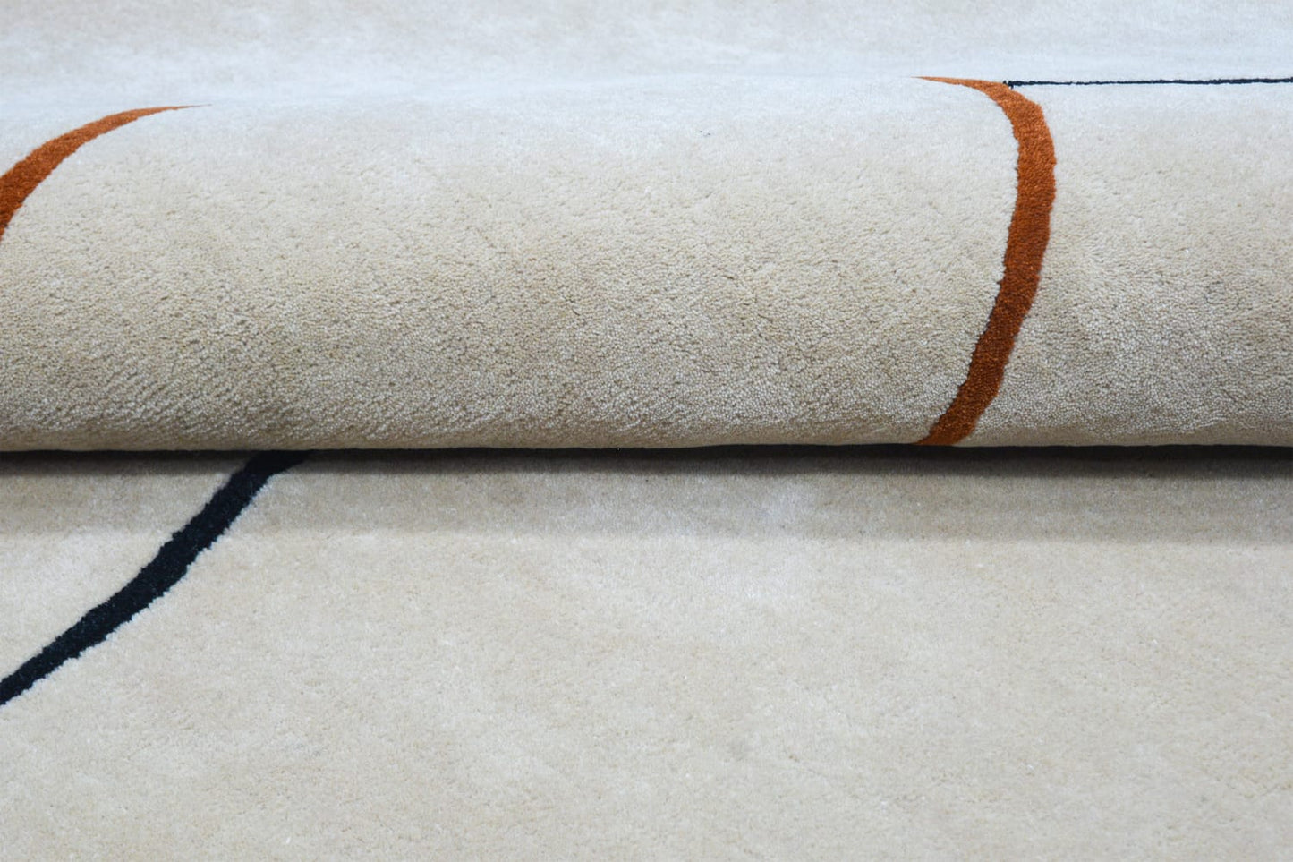 close-up view of Scollepd shaped wool & silk rug, showing texture detail