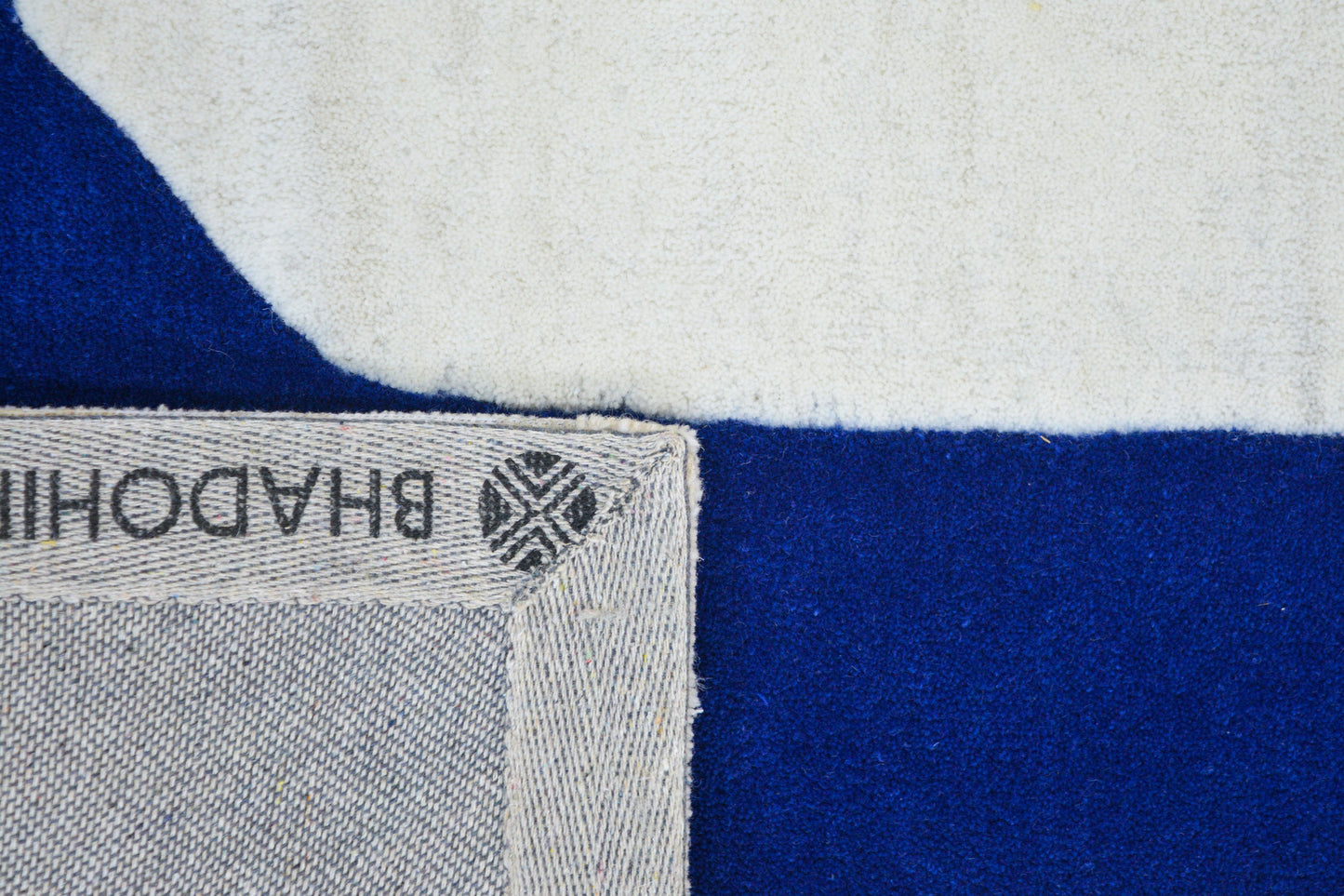 back side view of bhadohi blue hand tufted wool rug