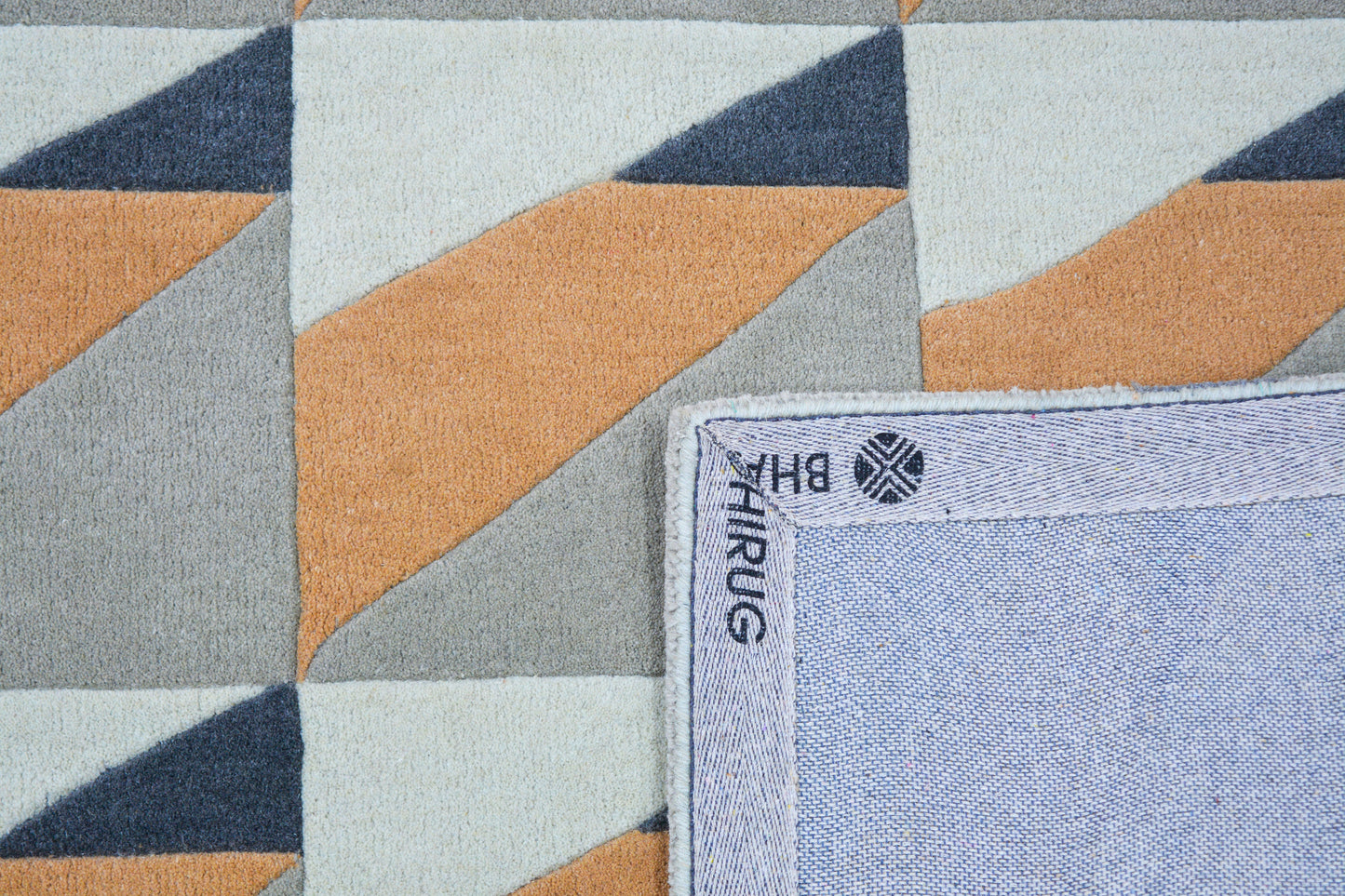 modern hand-tufted wool rug, showing back side of rug