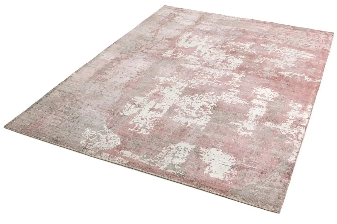 hand woven blush pink viscose rug on a white background