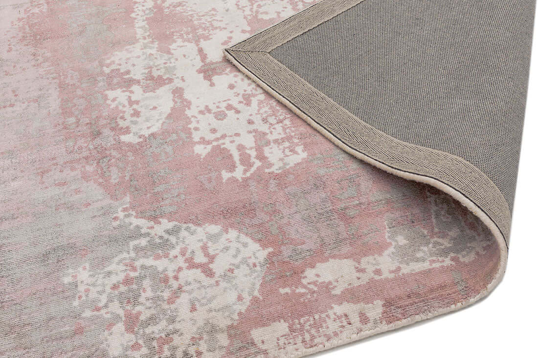 Close-up of a hand woven blush pink viscose rug corner