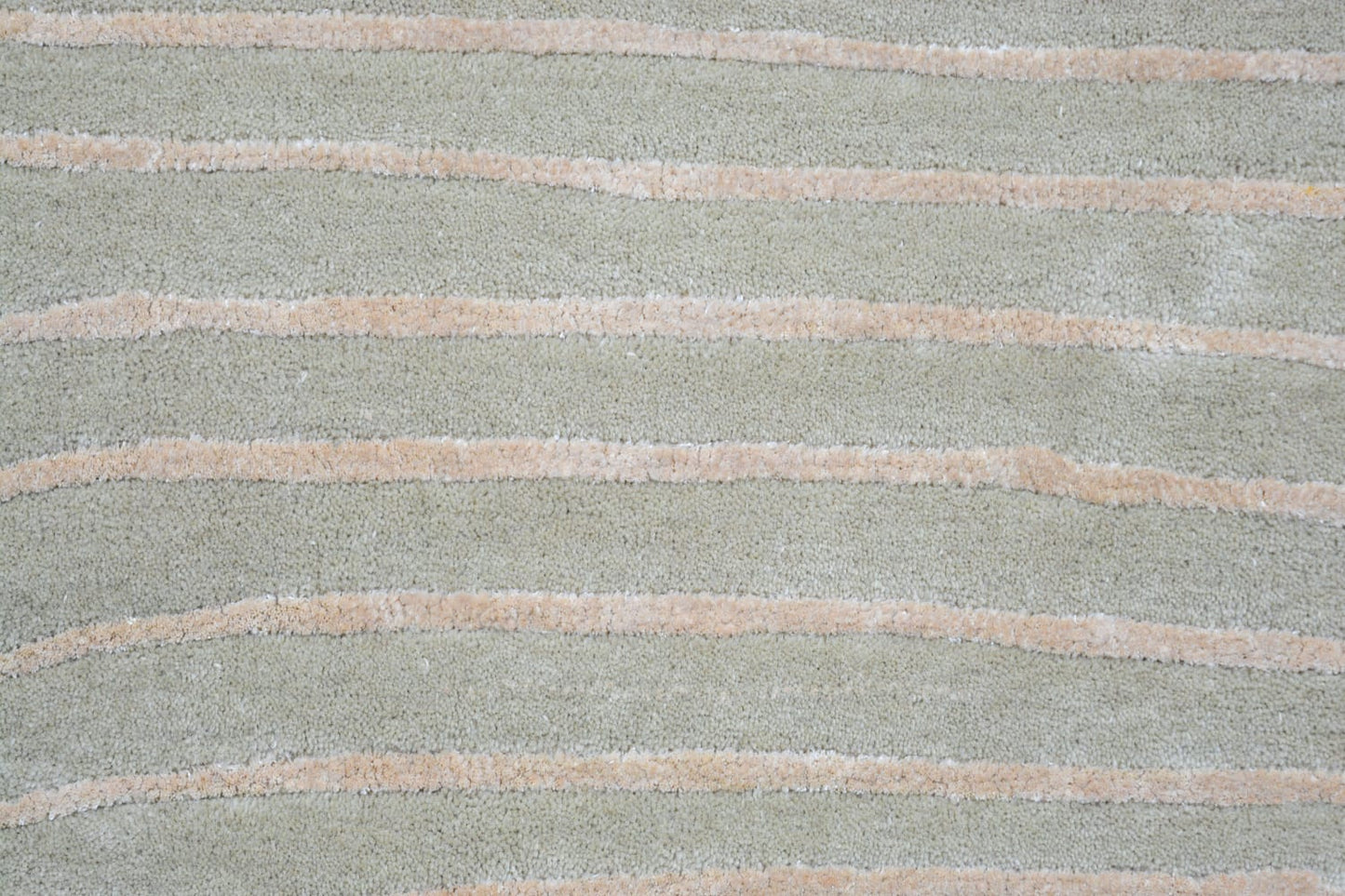 grey shaped wool rug, close view