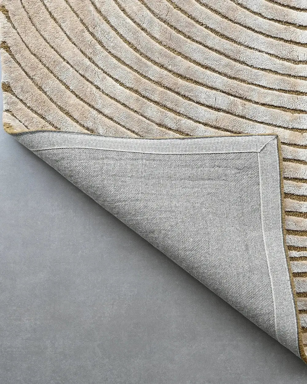 beige hand tufted silk carpet with circular geometric pattern