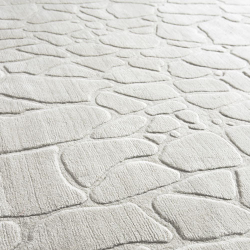 close view of modern style white wool rug, showing texture and design