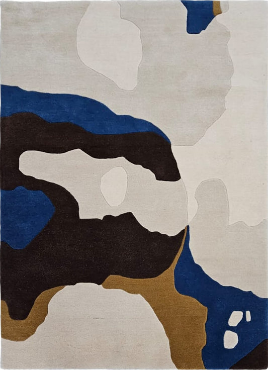 abstract hand tufted wool rug with blue, brown, and beige colors on a white background