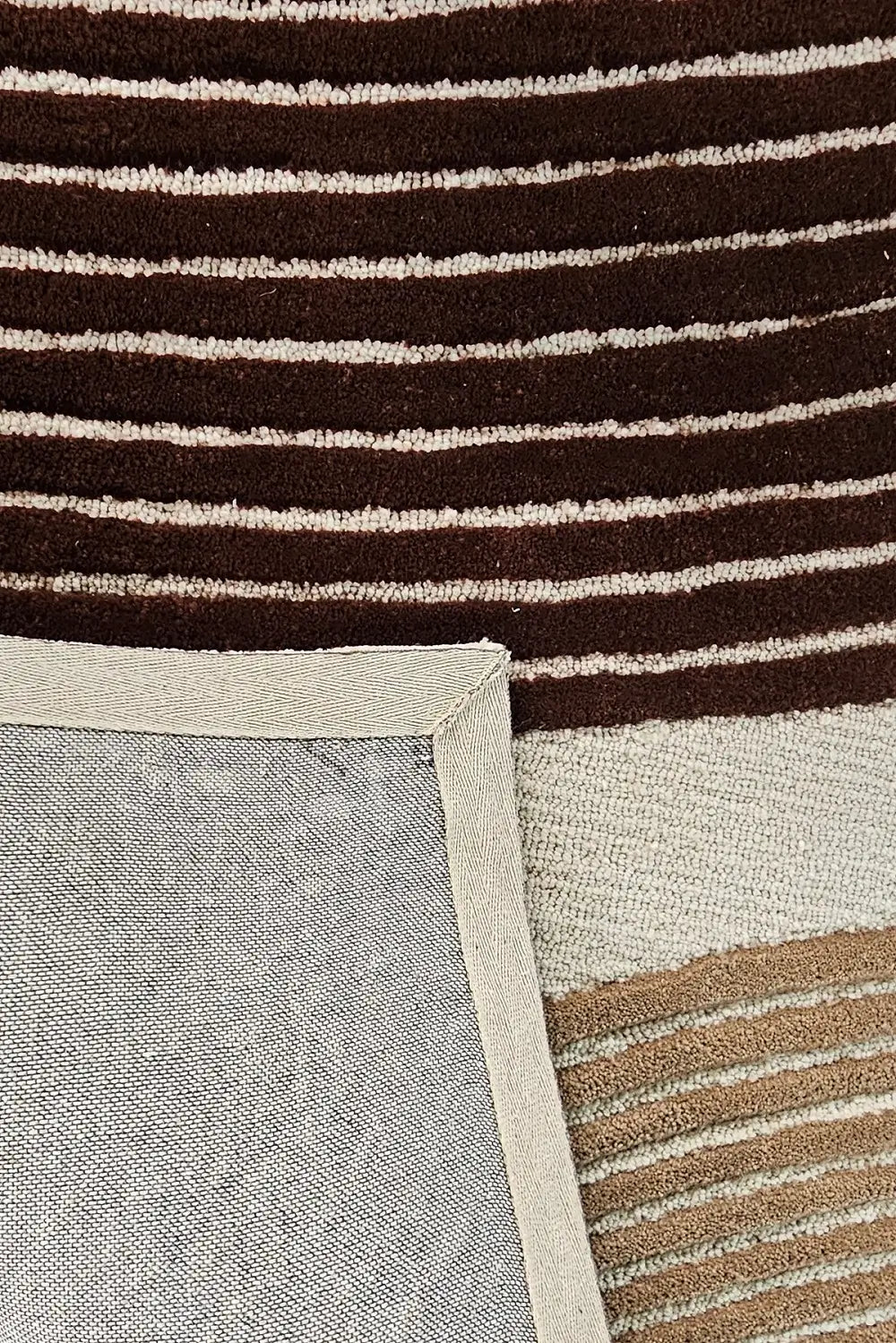 Close-up of a rug with brown and beige striped pattern