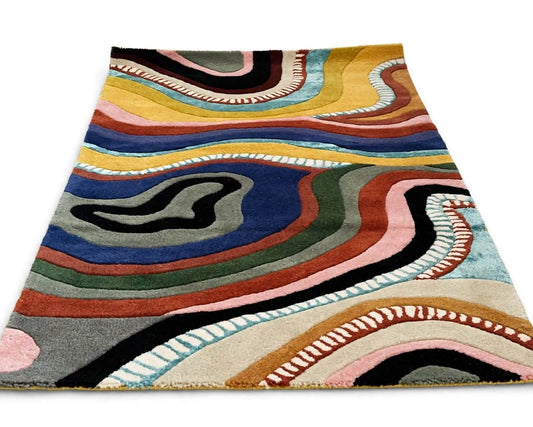 ringo hand tufted area rug featuring a vibrant, multicolored abstract wavy pattern