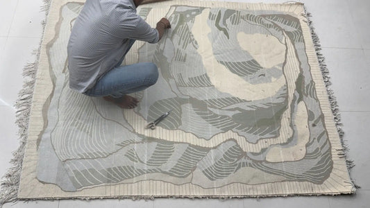 handmade wool rug finishing work by artisan