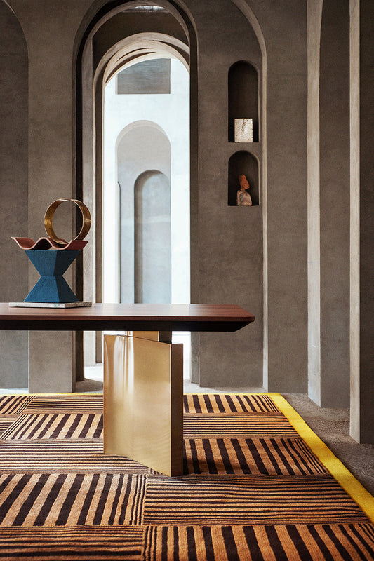 A table on modern hand tufted striped grid wool rug