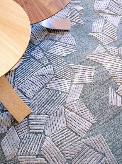Close-up of a hand tufted textured gray patterned carpet made of wool and silk