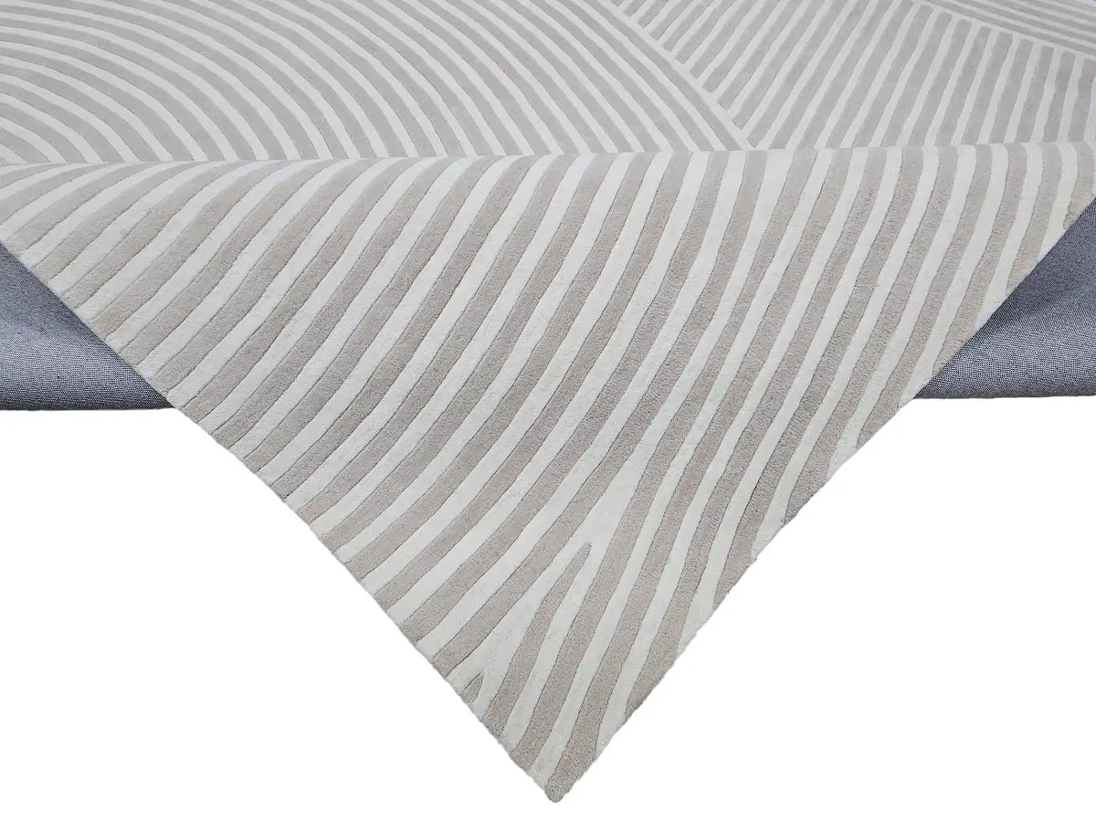 close view of Sequined hand tufted wool rug with gray and white striped design