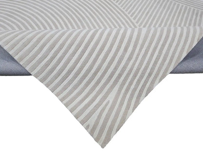 close view of Sequined hand tufted wool rug with gray and white striped design