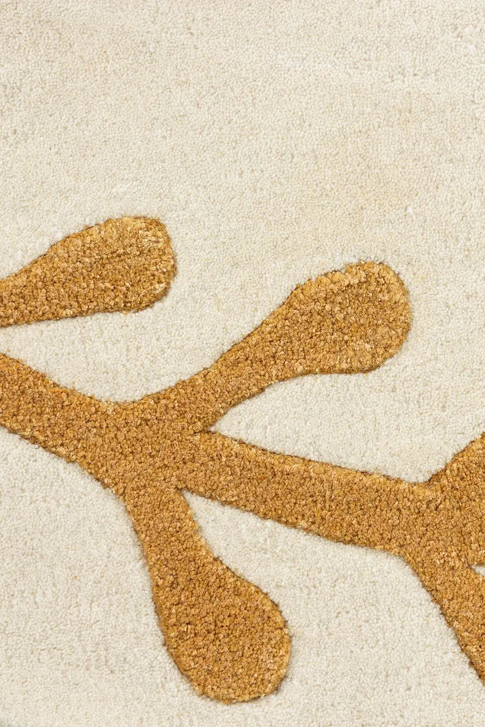 Close-up of a textured beige wool rug