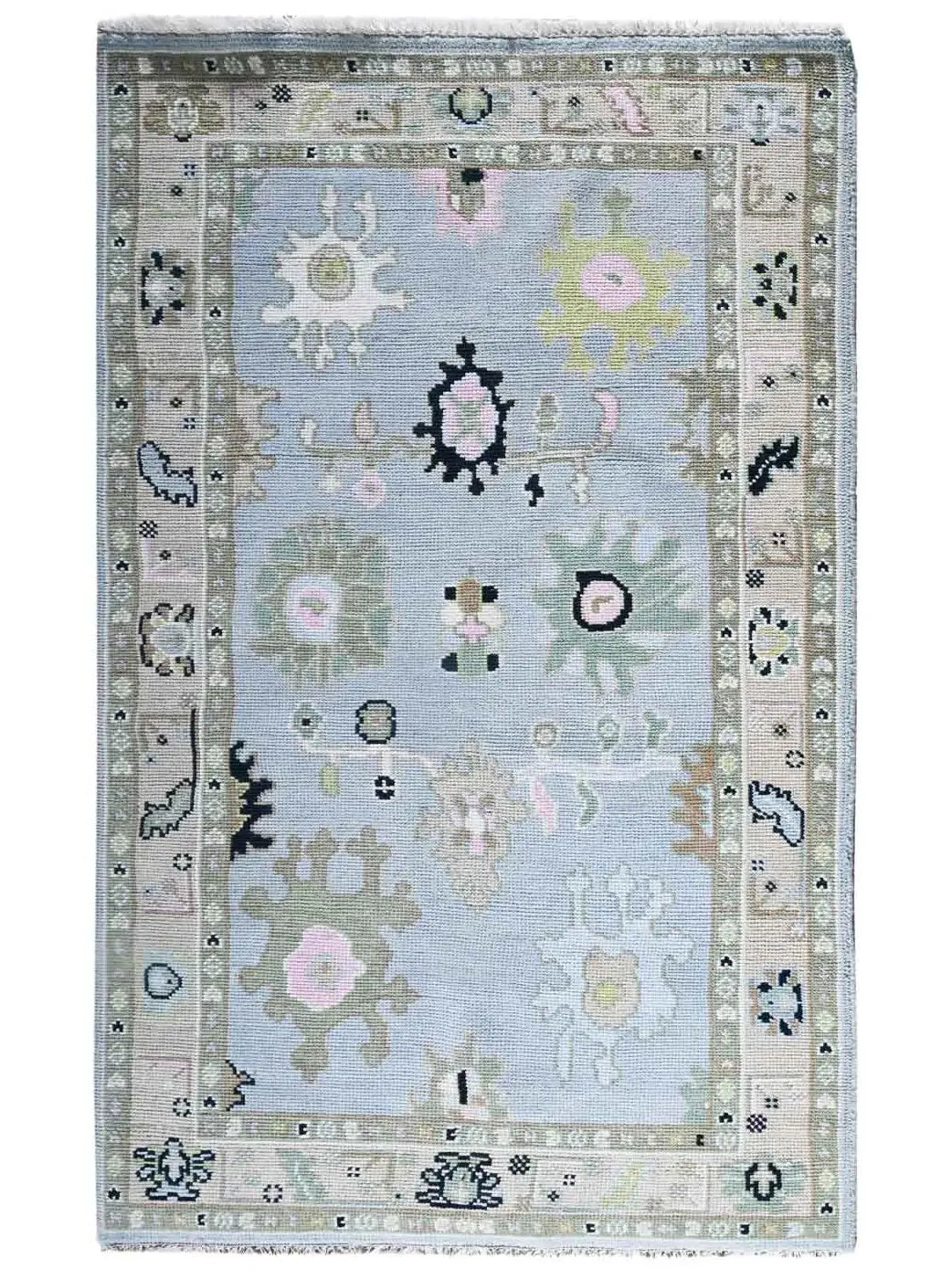 A classic hand knotted area rug with a light blue central field