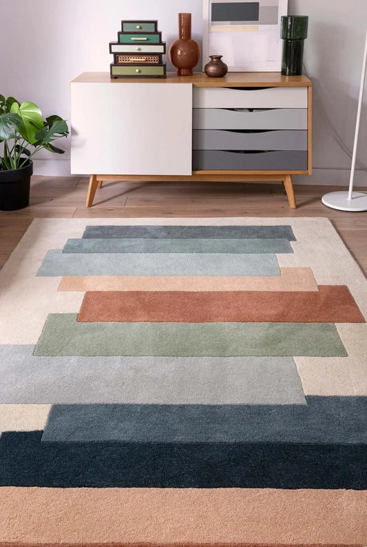 colorful handtufted wool rug on a wooden floor with a sideboard
