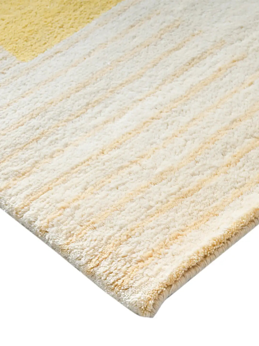 Close-up of a textured yellow and white rug corner