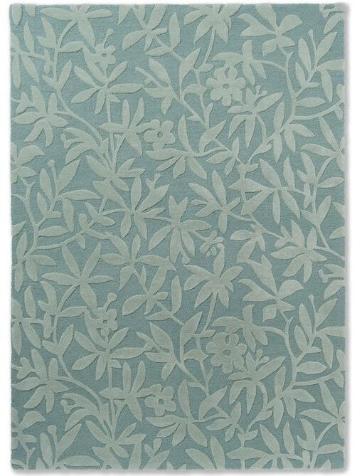 teal hand tufted wool rug with a leaf pattern