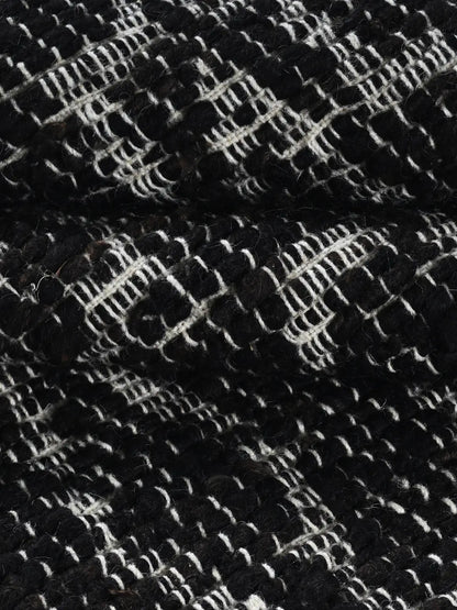 close up of hand woven black rug