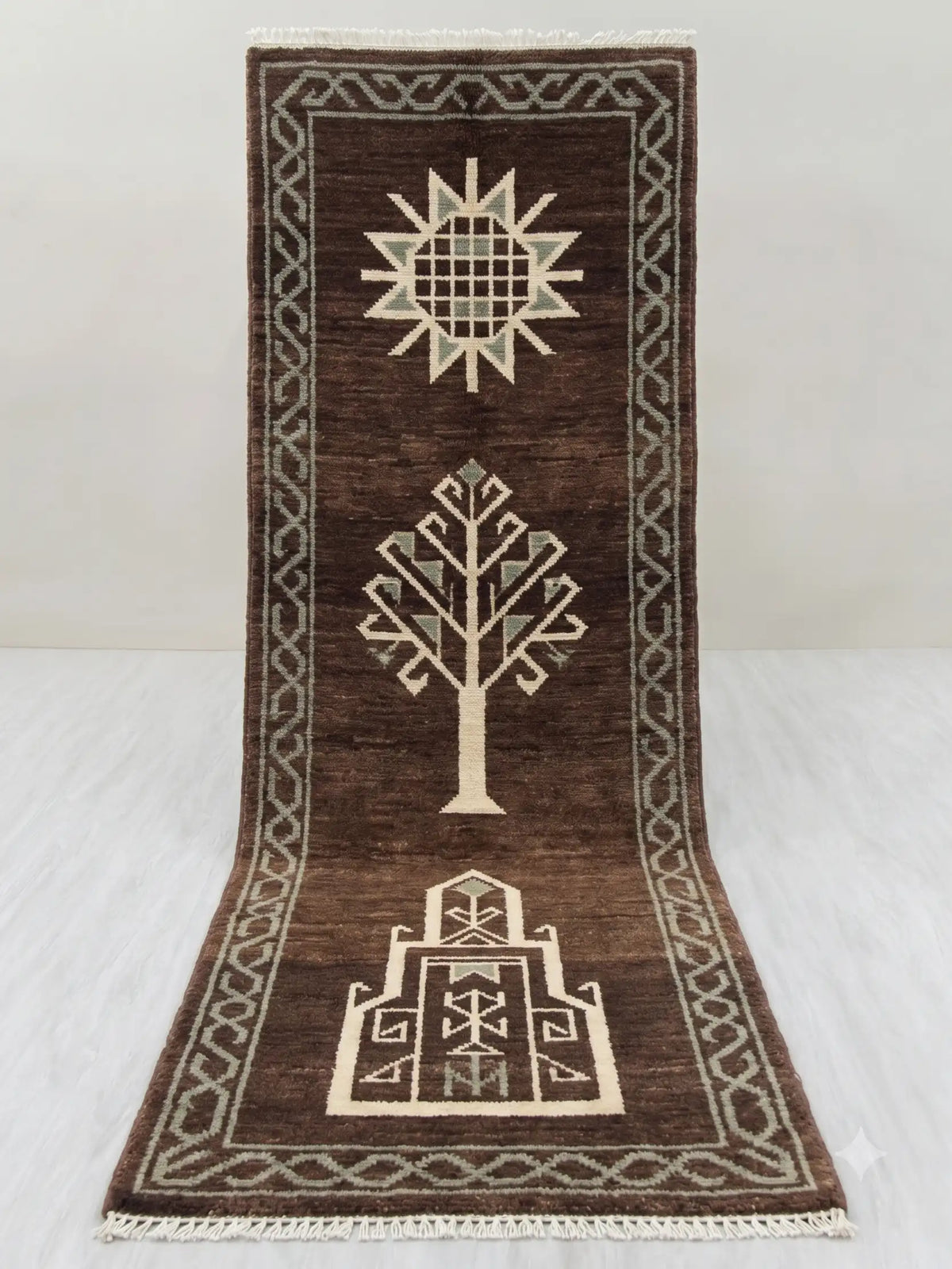 A dark brown hand knotted runner rug