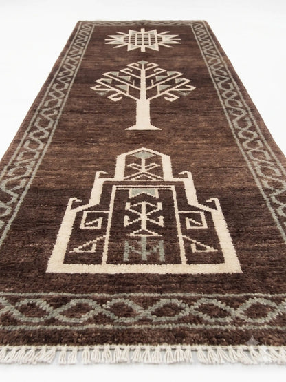 A dark brown wool runner rug