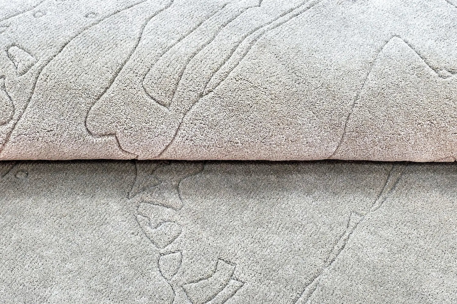 close view of hand tufted abstract textured gray wool rug with a subtle pattern
