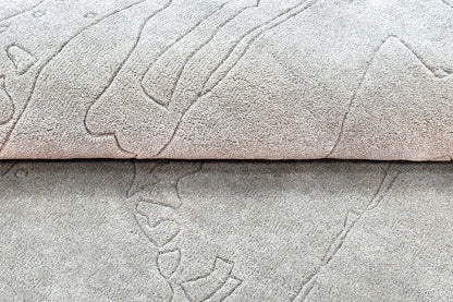 close view of hand tufted abstract textured gray wool rug with a subtle pattern