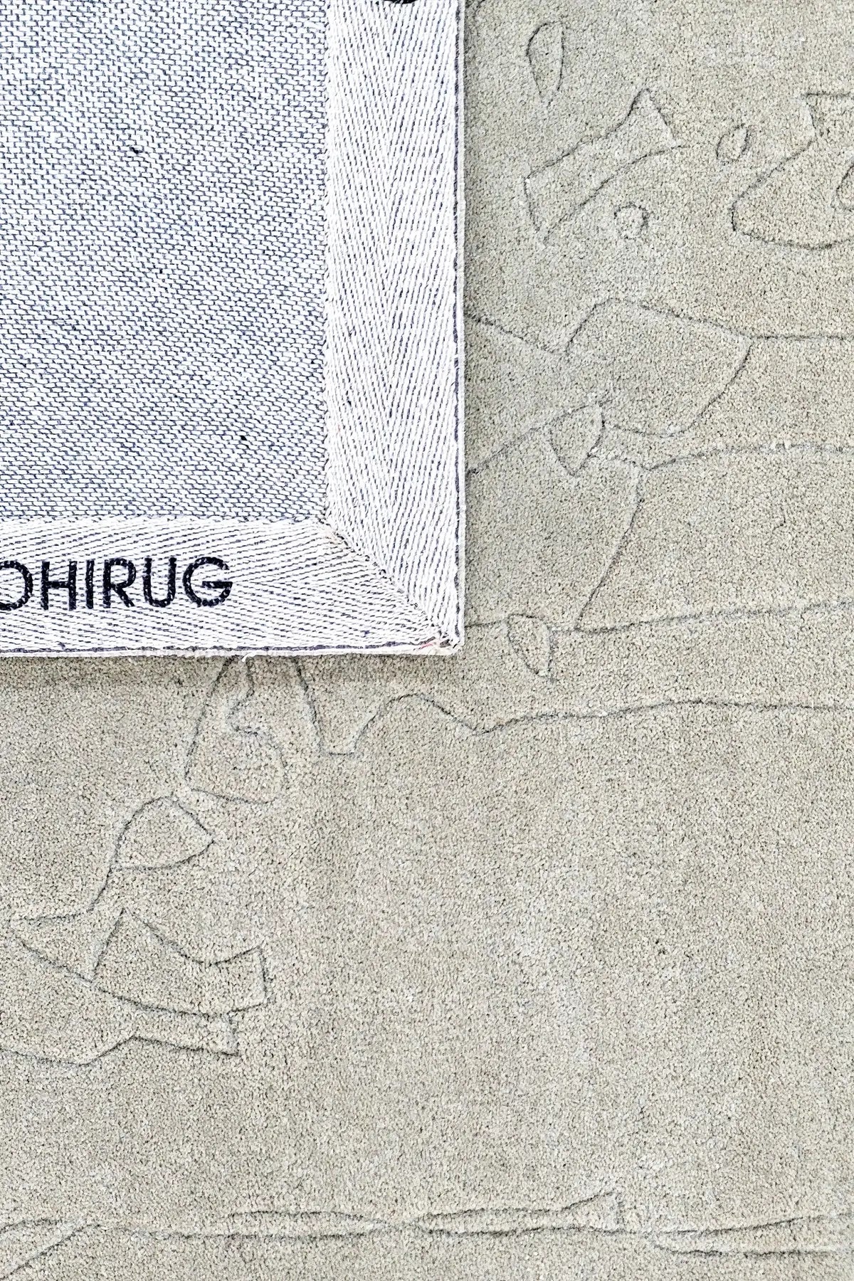 close and back view of hand tufted abstract textured gray wool rug with a subtle pattern