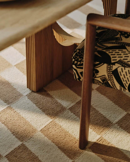 Wooden chair and table on a patterned hand woven carpet