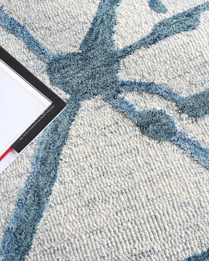 Close-up of a textured wool rug with blue abstract design