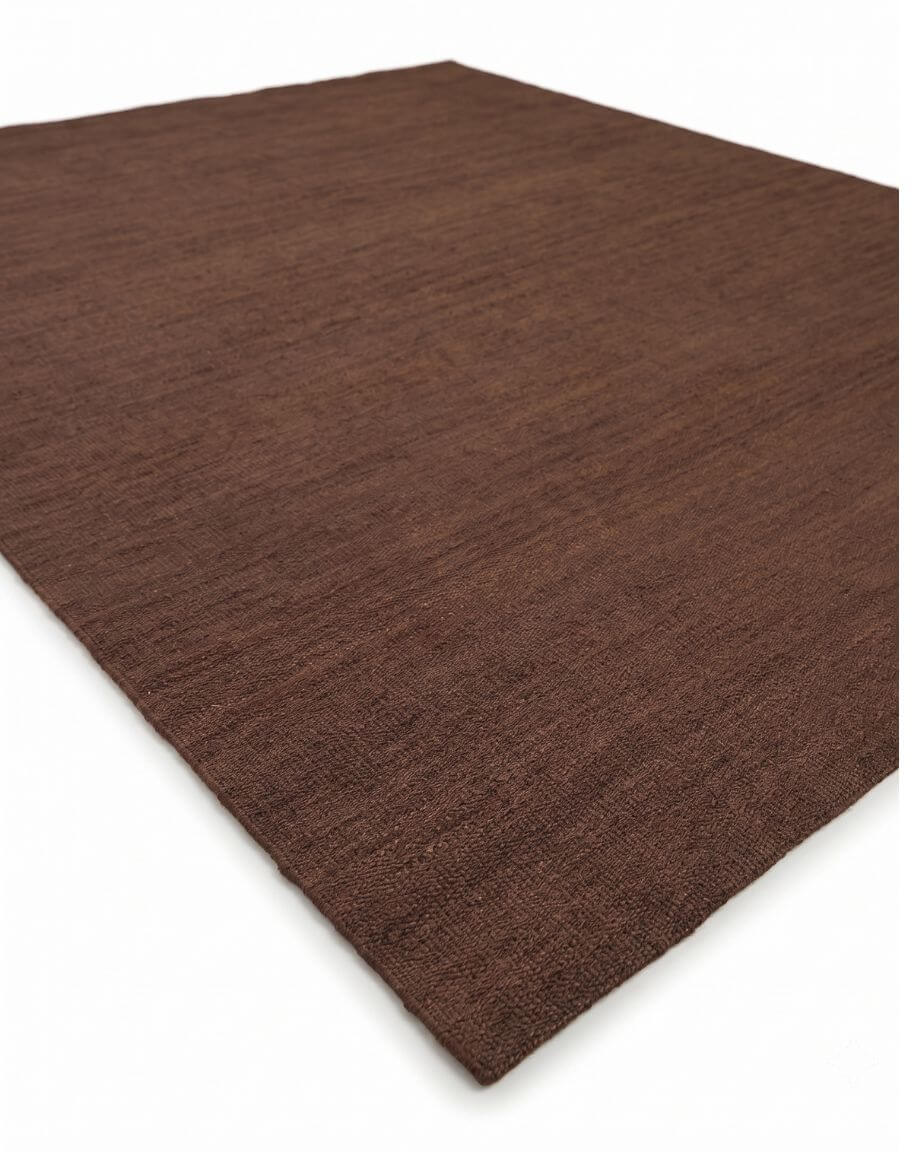 A dark brown textured jute rug