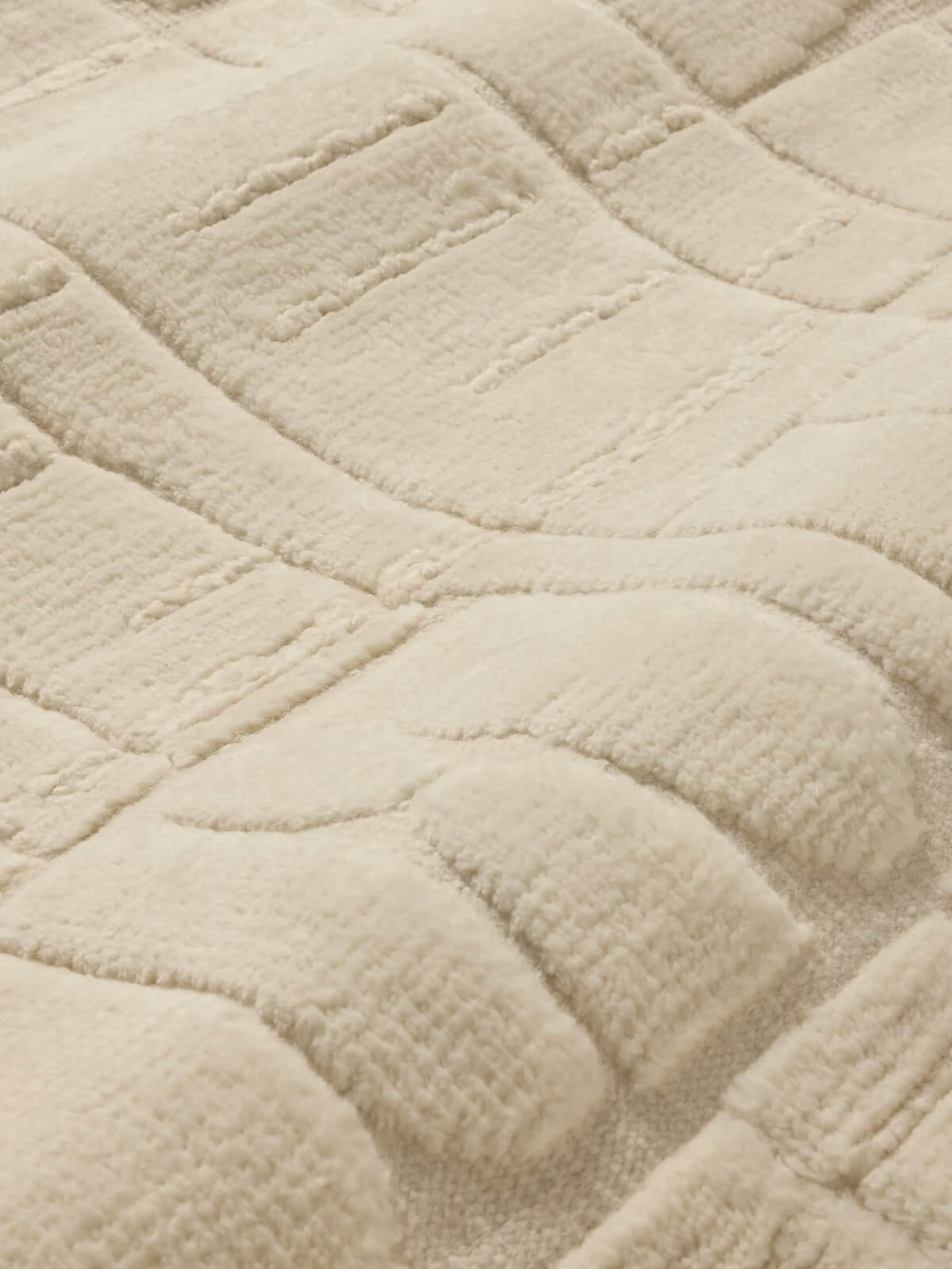 textured beige knotted wool rug close up