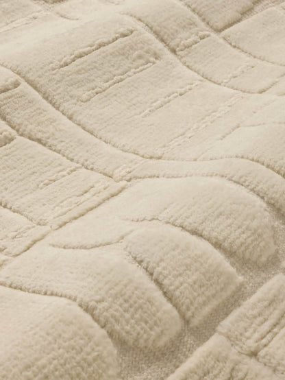 textured beige knotted wool rug close up