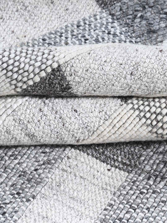 Close-up of textured gray and white rugs