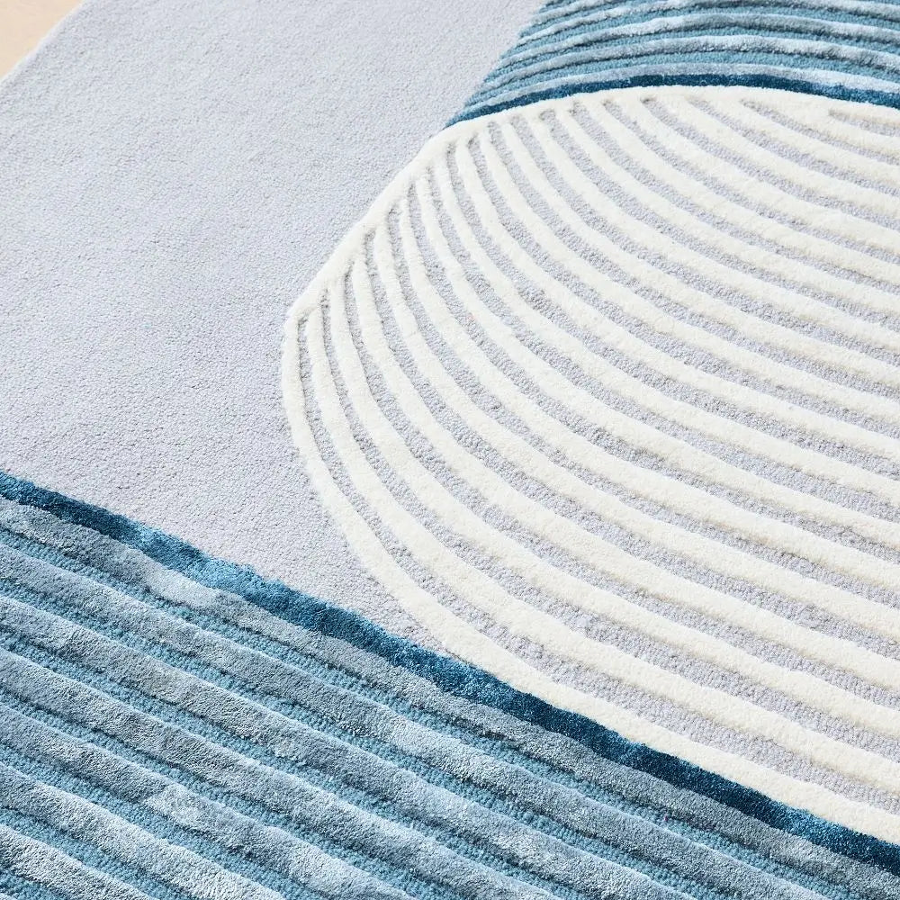 Close-up of modern rug with blue and white stripes