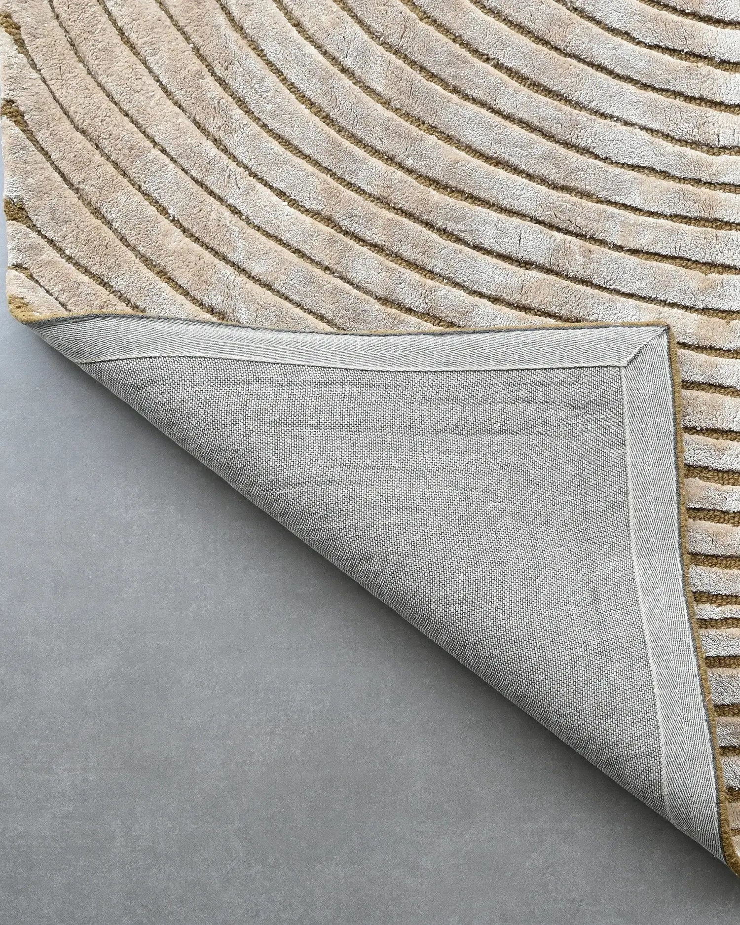 beige hand tufted silk carpet with circular geometric pattern