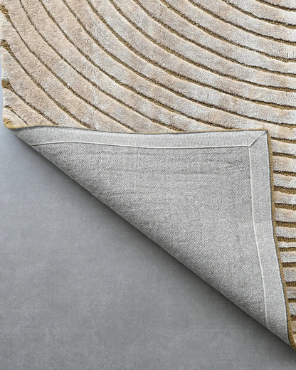 beige hand tufted silk carpet with circular geometric pattern
