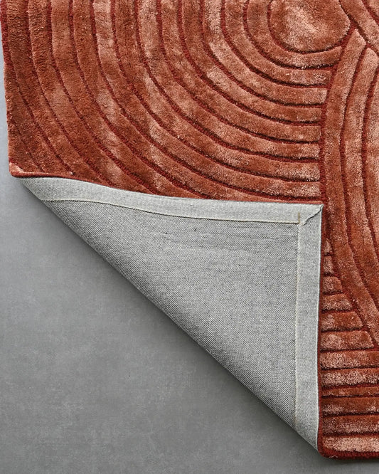 Textured brown hand tufted rug corner