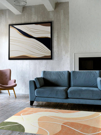 Living room with handtufted multi colour wool rug, a blue sofa, pink armchair, and abstract art on the wall.