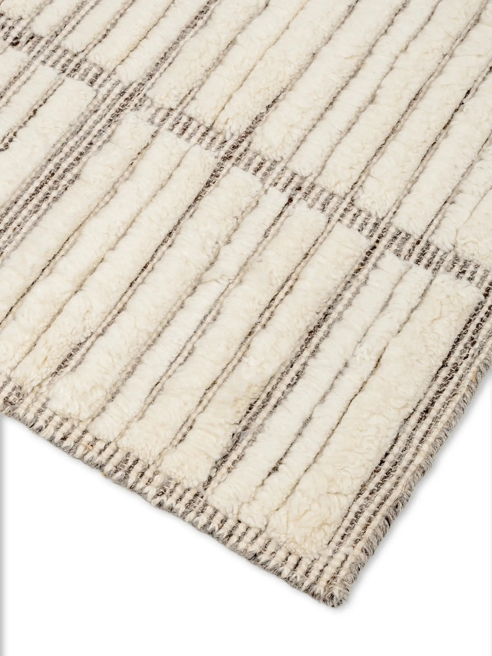 Close-up of a textured off white wool rug